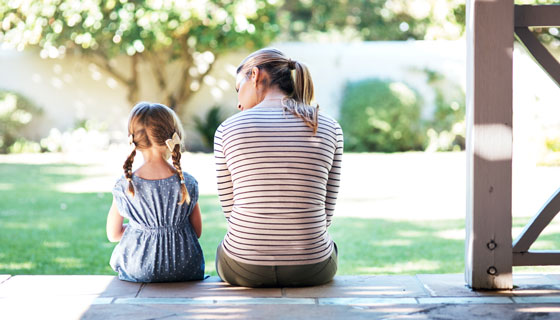 Mother Comforting Daughter Sitting